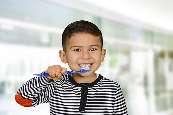 Child practicing brushing his teeth